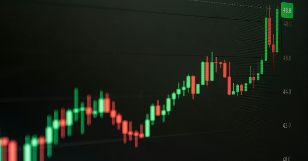Green candlesticks on a dark chart climbing steeply toward a new high
