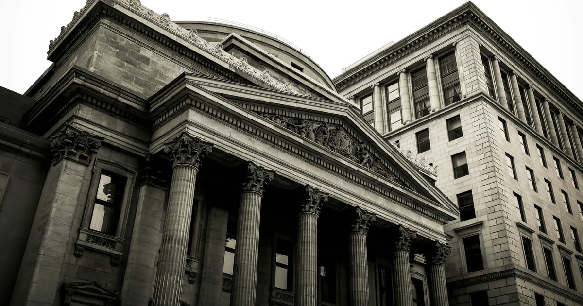 The stone columns and pediment of a classical government building