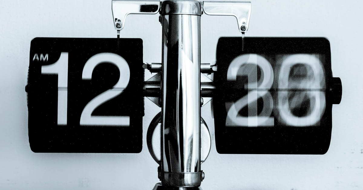 A large mechanical flip clock showing the time on split-flap digits